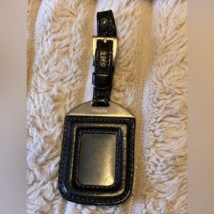 Authentic Prada luggage tag black pebble leather silver hardware gently used.